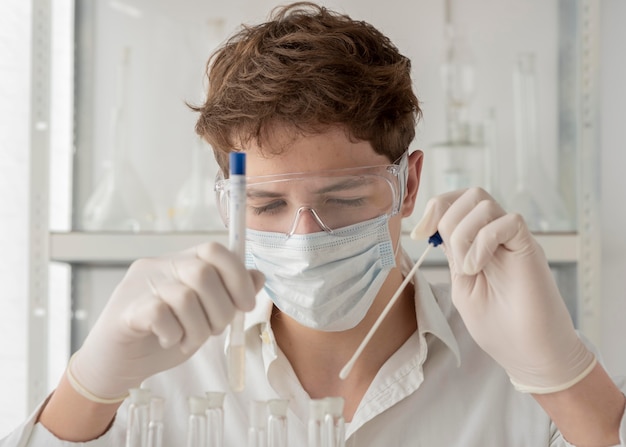 Close-up researcher looking at flask