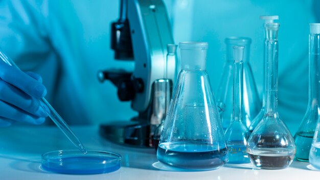 close-up researcher working with microscope