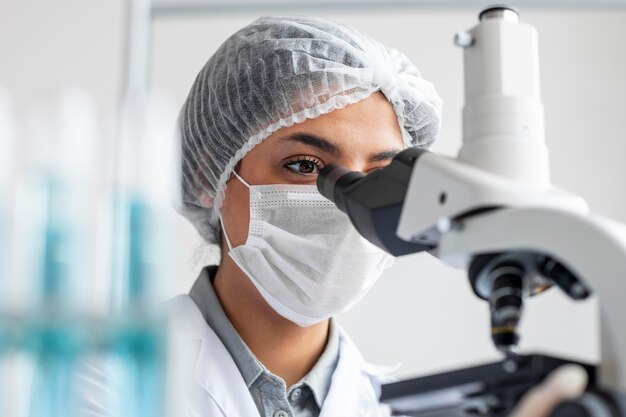 Close up researcher working with microscope