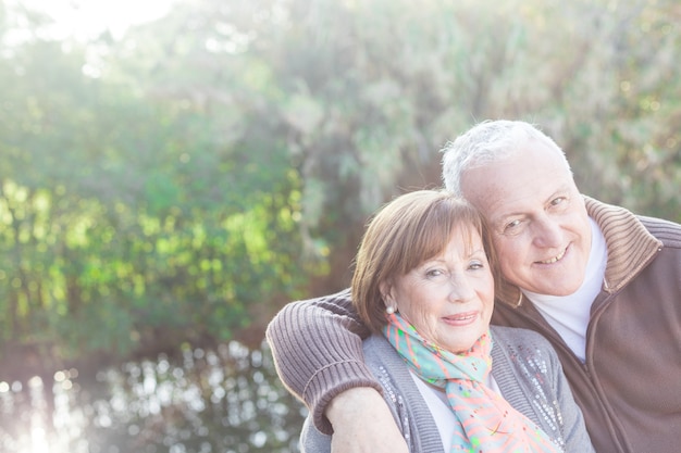 Close-up of retired man hugging his adorable woman