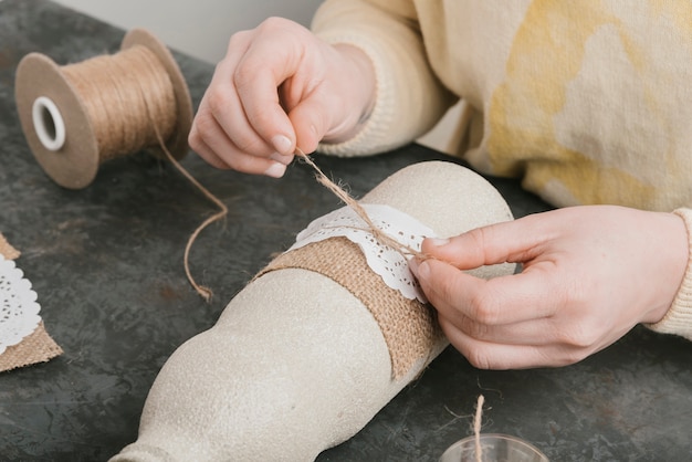 Close-up ribbon creation on beautiful vase 