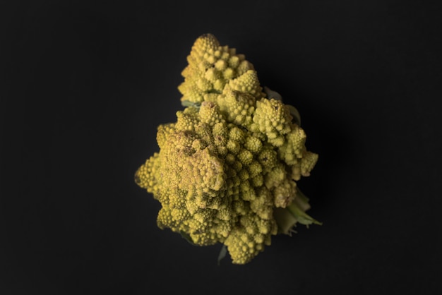 Close up of a ripe cauliflower isolated over black
