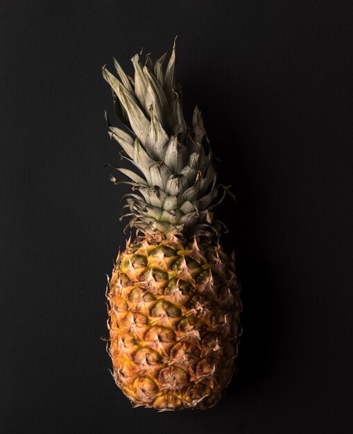 Close up of ripe pineapple isolated over black