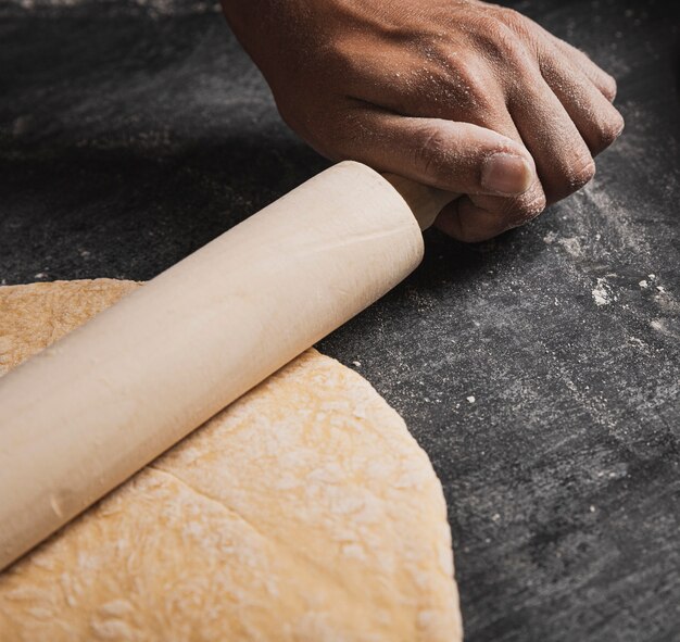 Close-up roller while rolling dough composition