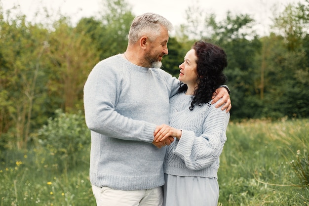 Close up romantic couple standing in autumn park  and hugging in daytime