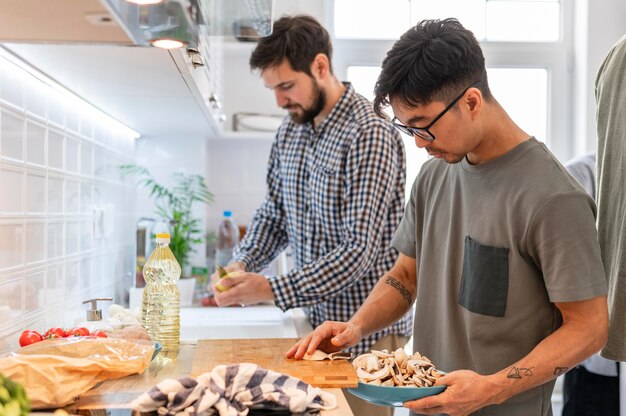 Close up roommates cooking together