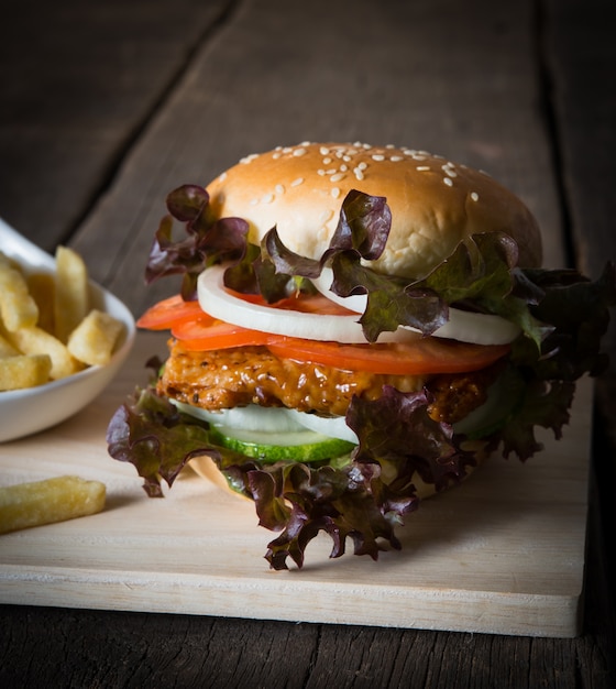 Close up of Rustic homemade hamburger and french fries.