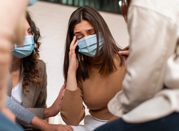 Free photo close up sad woman wearing mask