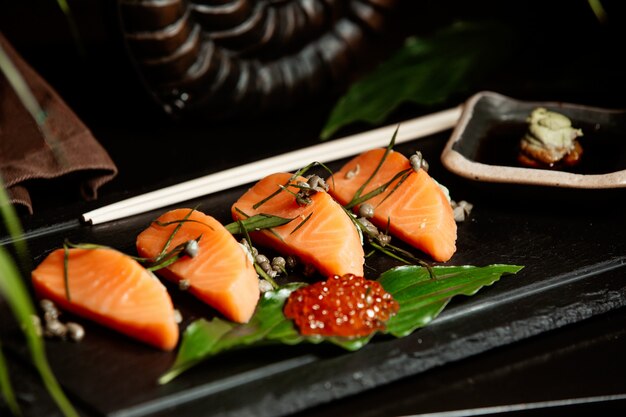 Close up of salmon sashimi served with red tobiko