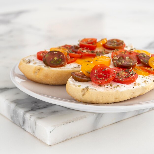 Close-up sandwiches with cream cheese and cherry tomatoes on plate