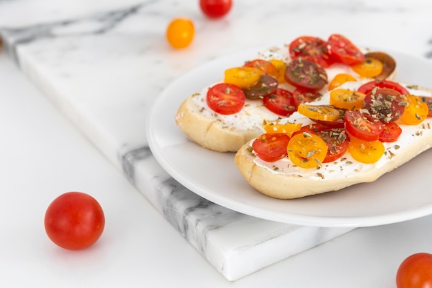 Close-up sandwiches with cream cheese and tomatoes on plate