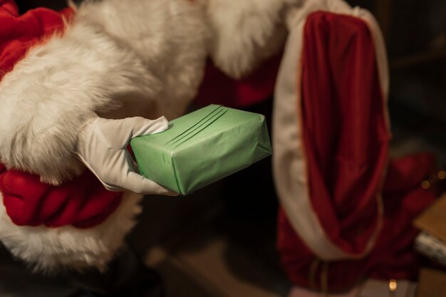Close-up santa claus holding xmas presents
