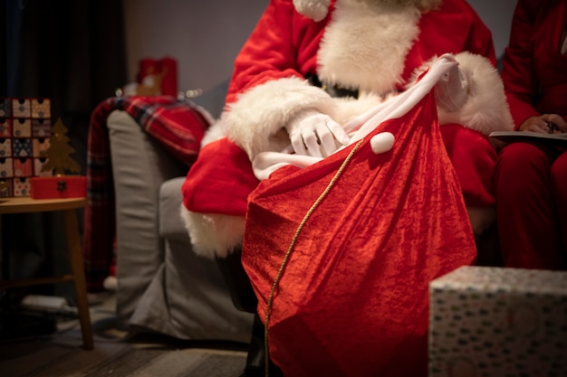 Close-up santa claus setting up presents