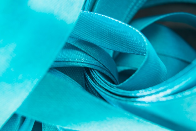 Close-up of satin blue curled ribbon