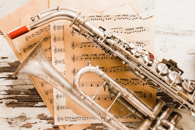 Close-up saxophone and trumpet on sheet music