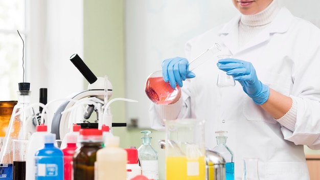 Close-up scientist holding flask