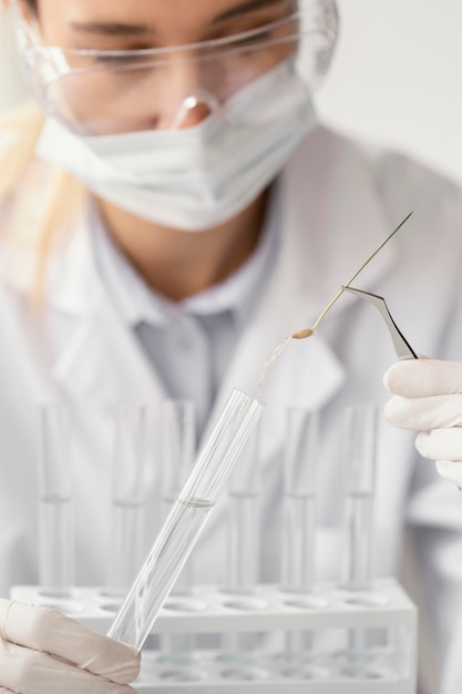 Free photo close up scientist holding tube