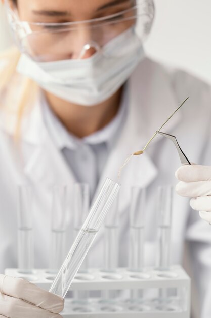 Close up scientist holding tube