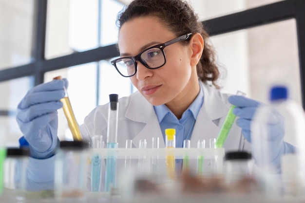 Close up scientist holding tube