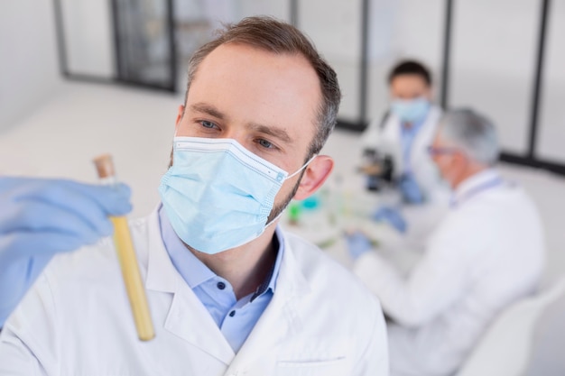 Close up scientist holding tube