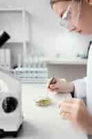 Free photo close up scientist holding tweezers