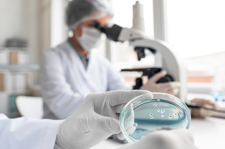 Free Photo close up scientist using microscope