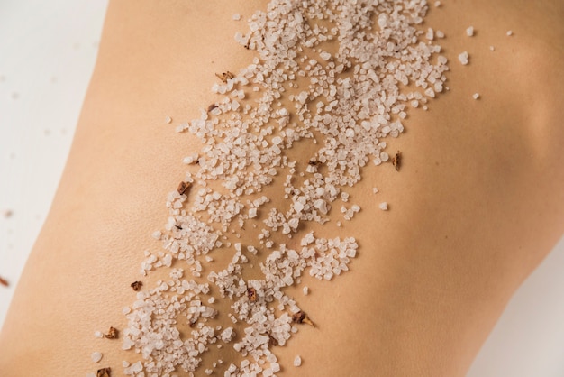 Close-up of sea salt on woman's back in spa