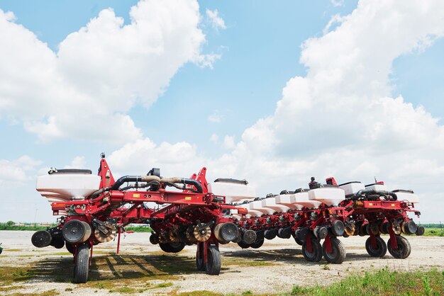 Close up of seeder attached to tractor in field.