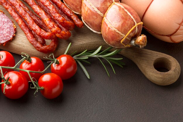 Close-up selection of fresh meat with tomatoes on the table