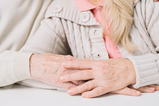 Close up of senior couple holding hands