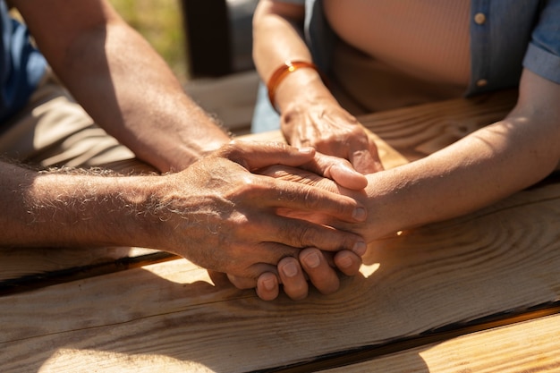 Close up senior couple holding hands