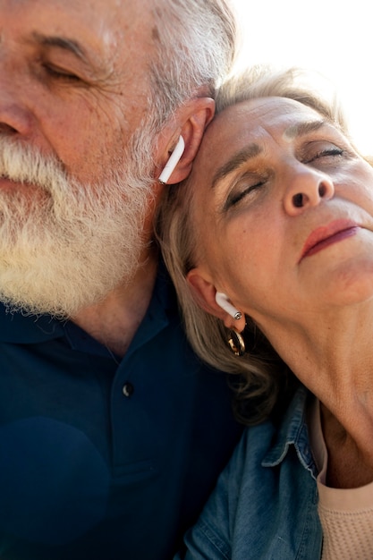 Free photo close up senior couple with earphones