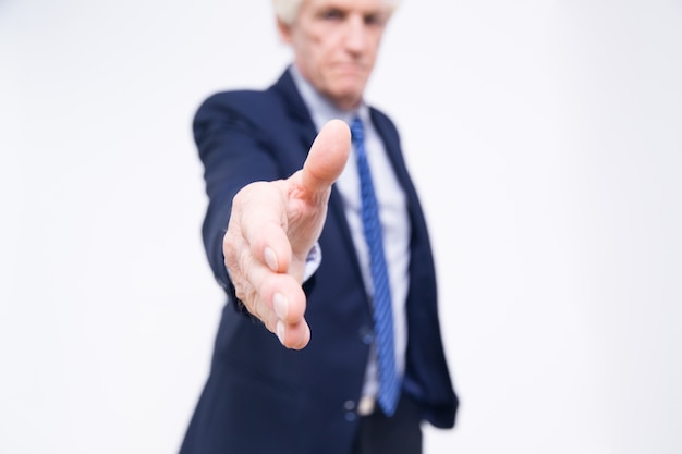 Close-up of senior hand extended for handshake