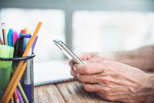 Close-up of senior man's hand holding smart phone