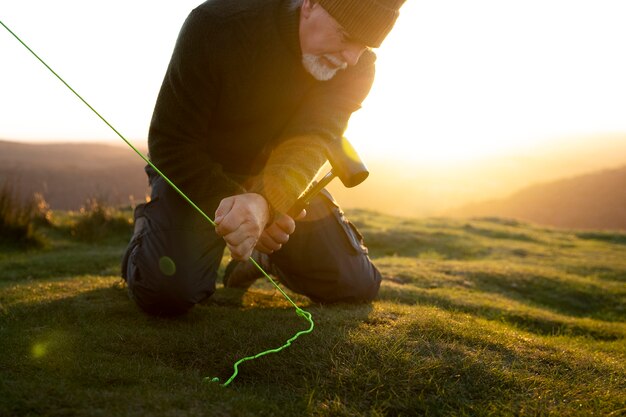 Close up senior man setting up tent