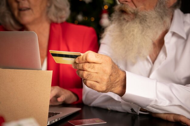 Close-up senior man and woman with credit card