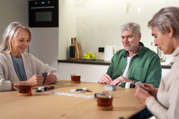 Free photo close up senior people playing poker