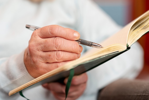 Close-up senior woman taking notes