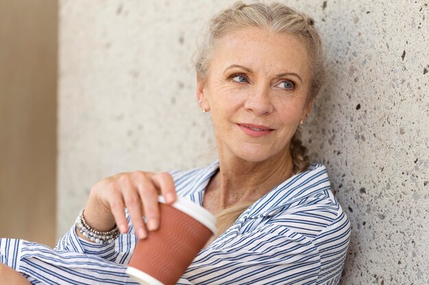 Close up senior woman with coffee cup