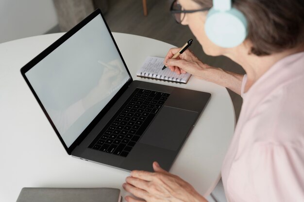 Close up senior woman with laptop