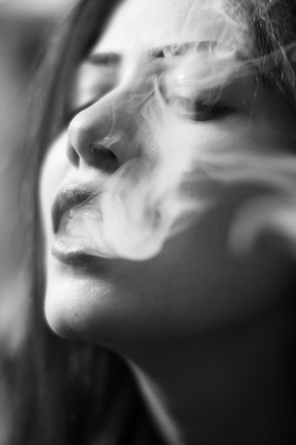 Close-up of sensual woman smoking