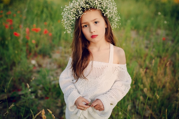 Close-up of serious schoolgirl in the meadow