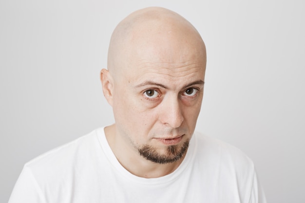 Close-up of serious thoughtful bald man with beard