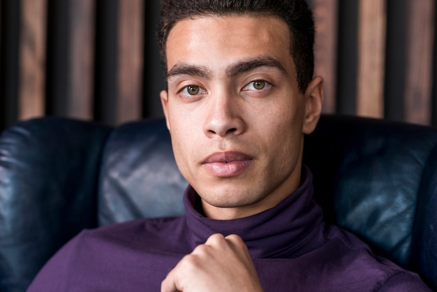 Close-up of serious young man looking at camera