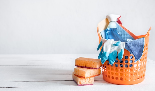 Close up set of home cleaning products in a bright basket. Means for maintaining cleanliness  background