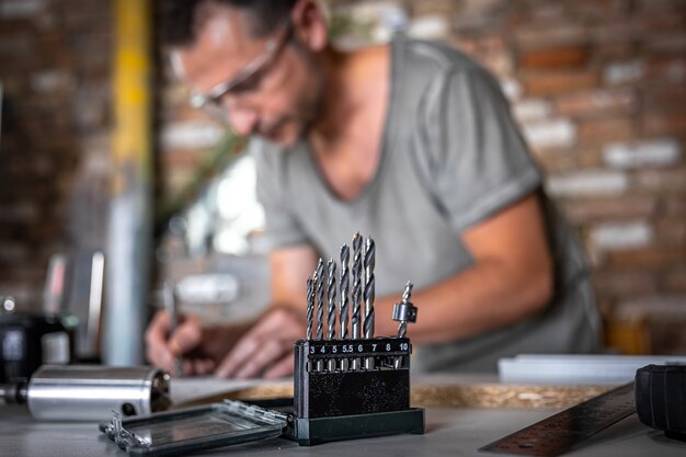 Close up of a set of wood drills on a work table of a joiner in a workshop.