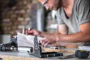 Free photo close up of a set of wood drills on a work table of a joiner in a workshop.