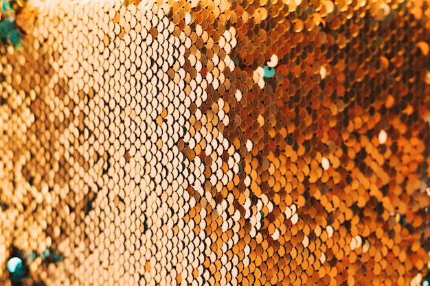 Close-up of shiny golden sequin material