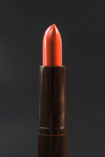 Free photo close-up of shiny red lipstick against black backdrop