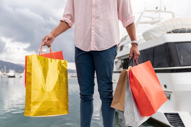 Close-up shopping bags near boat